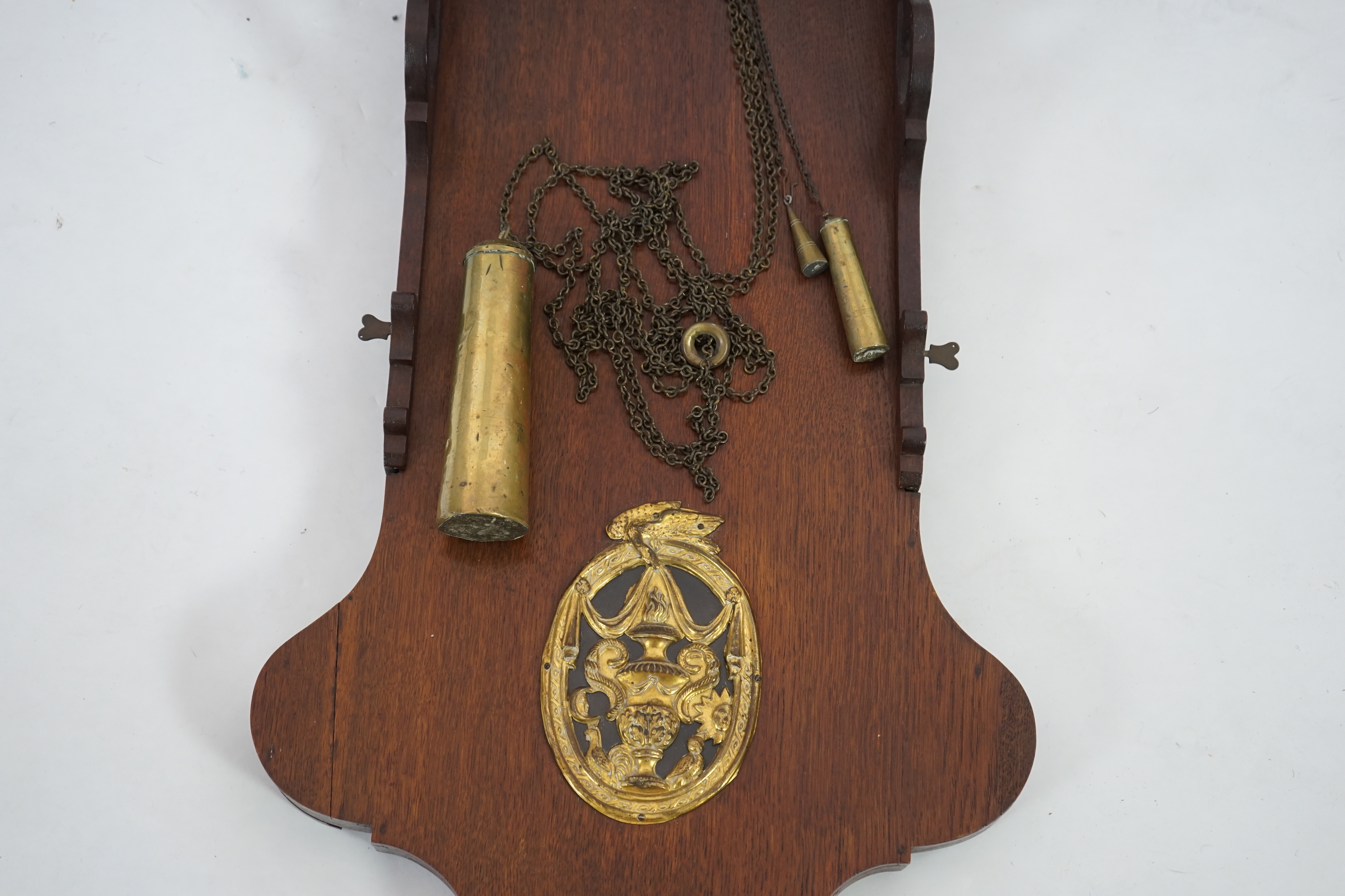 A late 18th century Dutch Frisian Staart oak eight day wall clock, with atlas and angel finials, hood painted with a Dutch riverscape and painted arched dial with moonphase, date aperture and alarm indicator, 47cm wide,